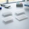 96-well microplate with transparent pcr plate lid placed on a laboratory bench near scientific equipment
